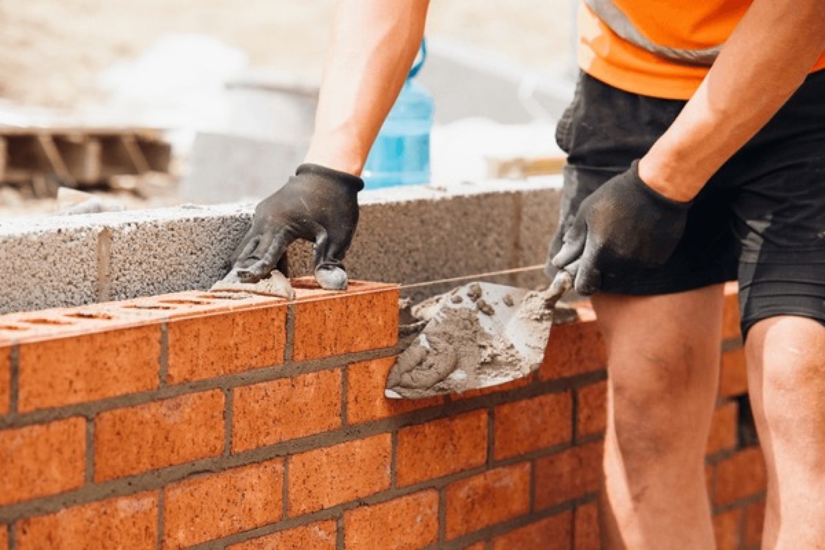 Construction worker using trowel in New York